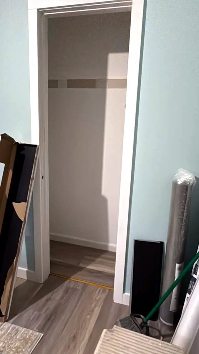 Empty narrow closet before custom storage work
