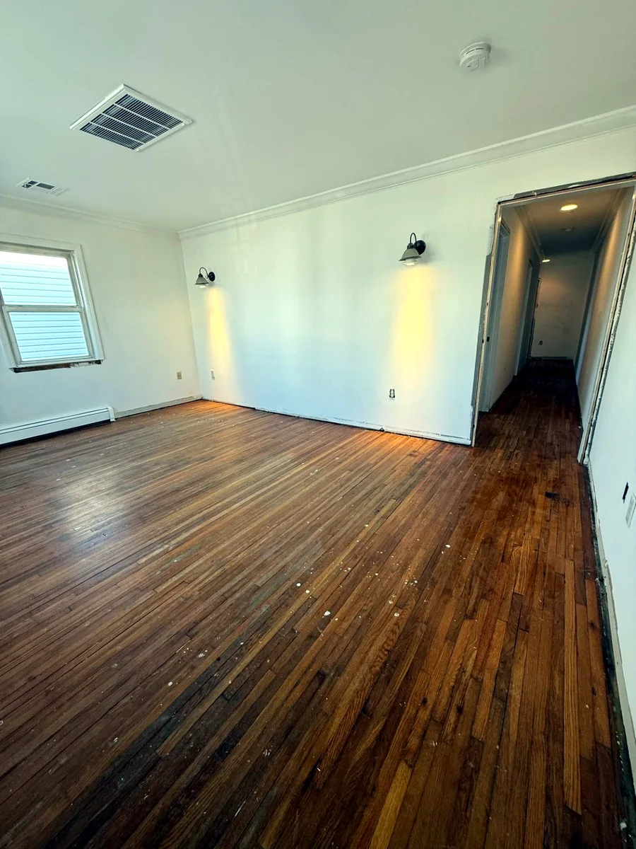 Living room before new flooring painting lighting and wall upgrades