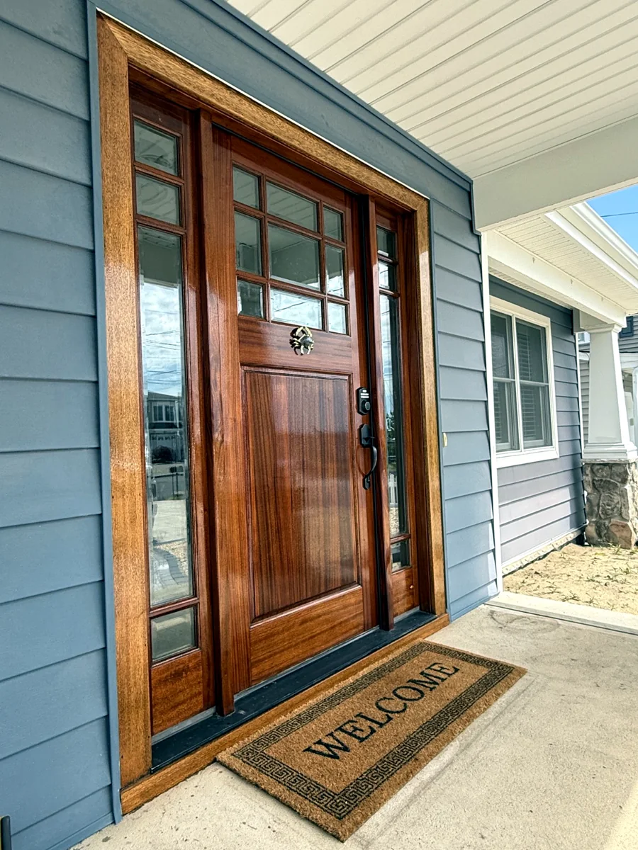 Natural wood front door after full restoration and UV protective varnish